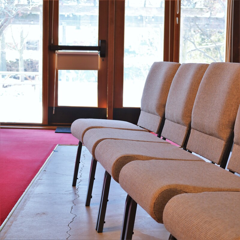 A photograph taken inside the Harcourt Sanctuary of a row of chairs that we have for our seating, rather than traditional pews.